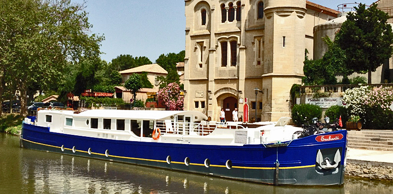 Enchante moored in village